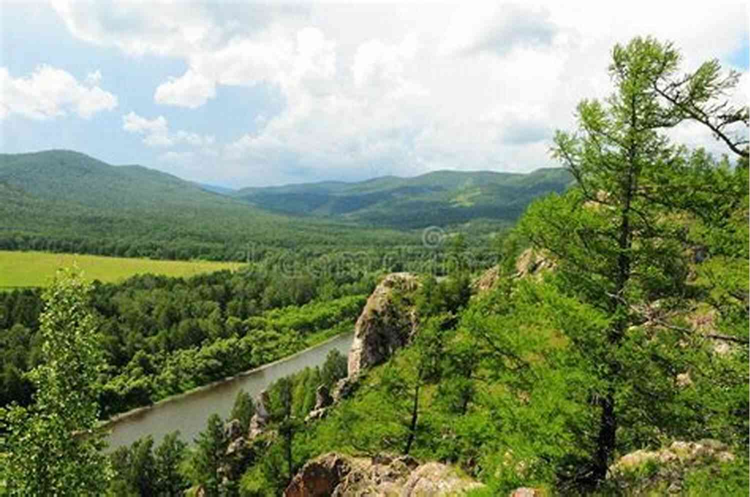 A Peaceful Valley Surrounded By Majestic Mountains With A Flowing River In The Middle Where The World Is Quiet
